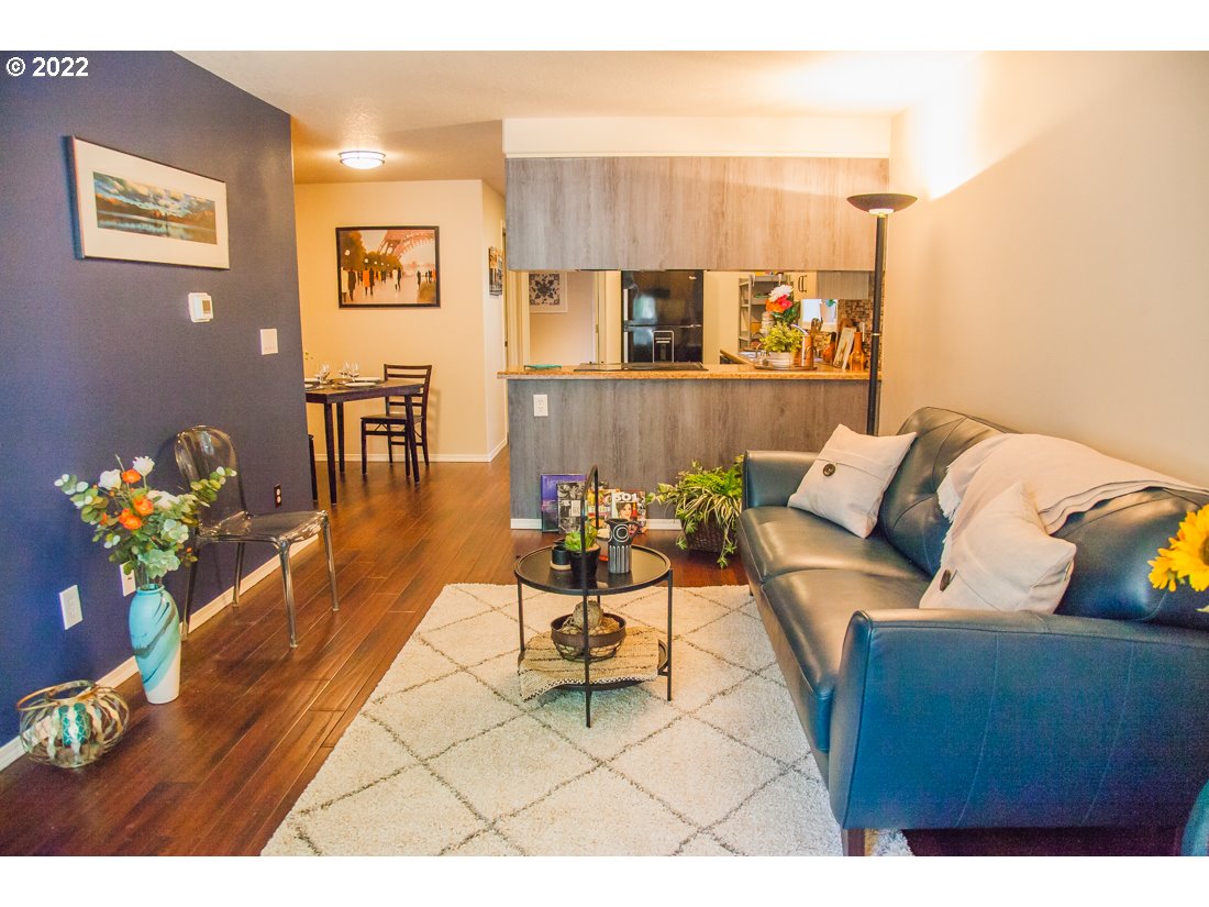 12642 Southeast Foster Road, Unit A Portland, OR 97236 - Photo 5 of 23 a living room with furniture flowerpot and wooden floor