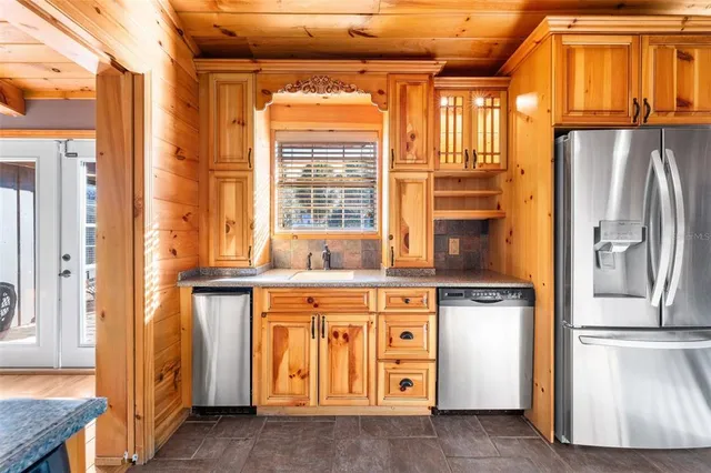 a kitchen with stainless steel appliances granite countertop a sink and cabinets