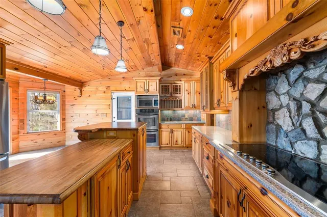 a kitchen with stainless steel appliances granite countertop a stove and a refrigerator