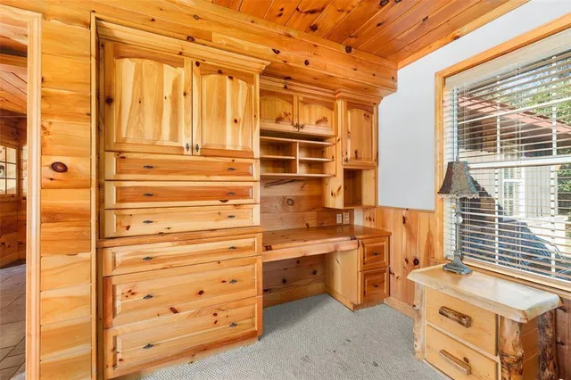 a bathroom with a granite countertop sink a mirror and a shower