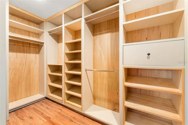 a bathroom with a granite countertop sink a mirror and a bathtub