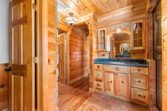 a bathroom with a granite countertop sink and a mirror