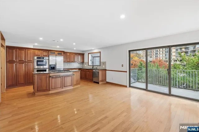a kitchen with stainless steel appliances granite countertop a stove and a sink