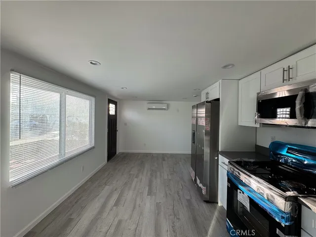 a kitchen with stainless steel appliances a stove sink and refrigerator