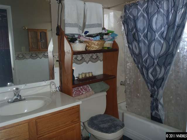 1801 Haddock Drive Reno, NV 89512 - Photo 8 of 10 a bathroom with a toilet sink and mirror