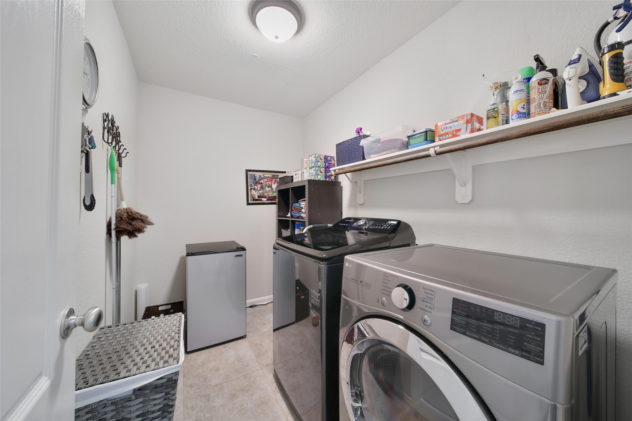 214 Pleasant Hill Way Conroe, TX 77304 - Photo 30 of 43 What a great laundry room! Whether you need space for an extra fridge or additional storage cabinets, there's room for it in here.