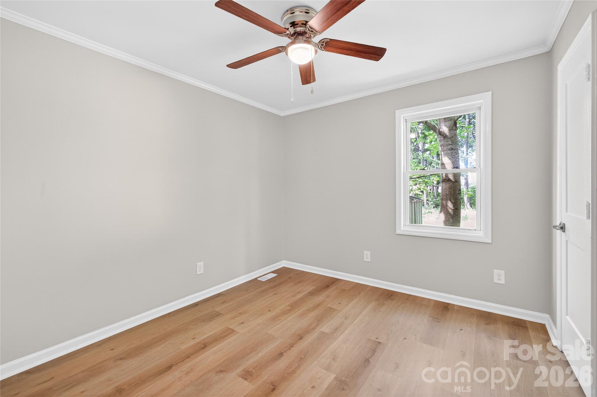 116 Middleton Avenue Matthews, NC 28104 - Photo 17 of 22 an empty room with a window and a fan