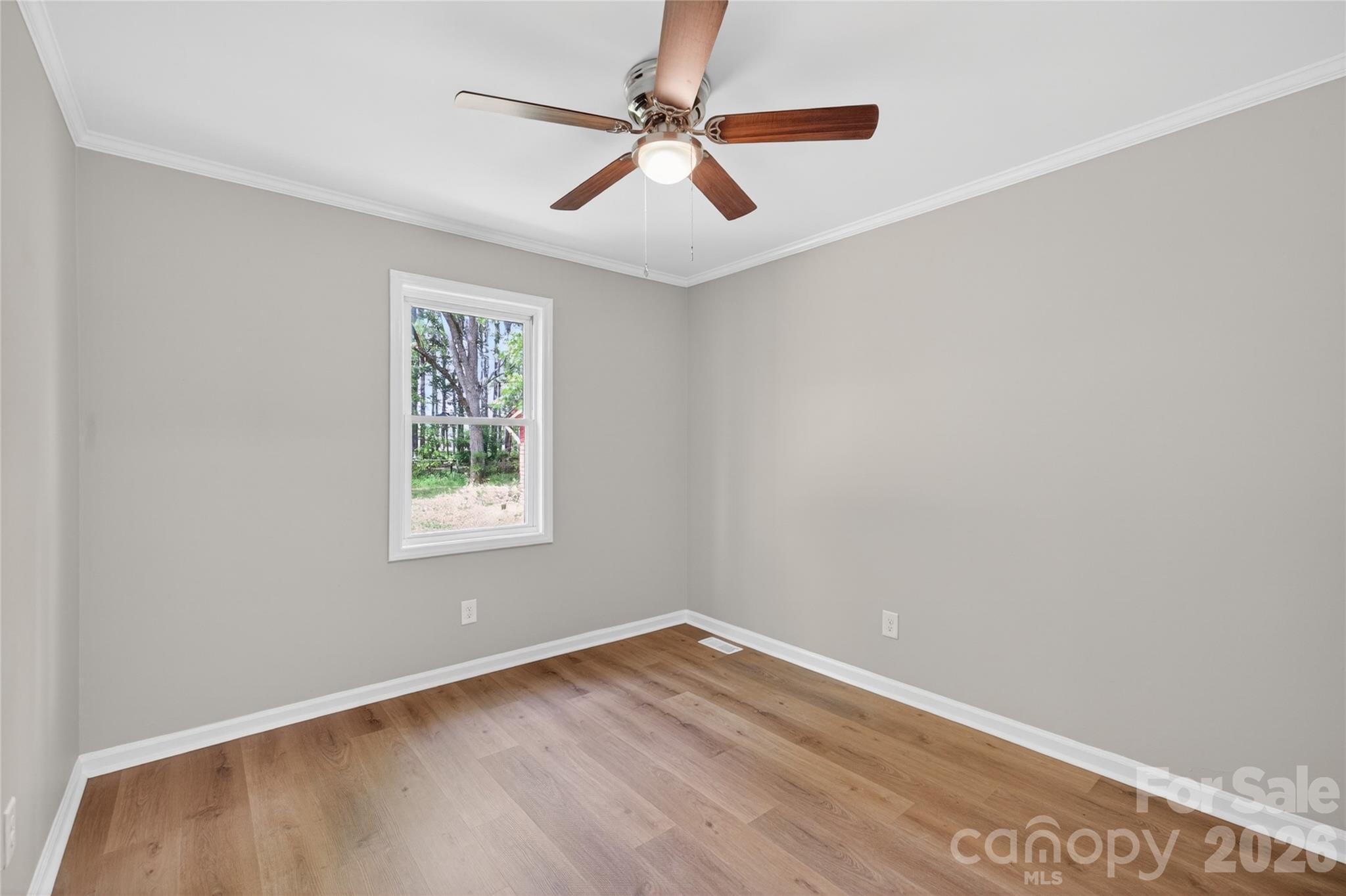 116 Middleton Avenue Matthews, NC 28104 - Photo 18 of 22 an empty room with a window and a ceiling fan