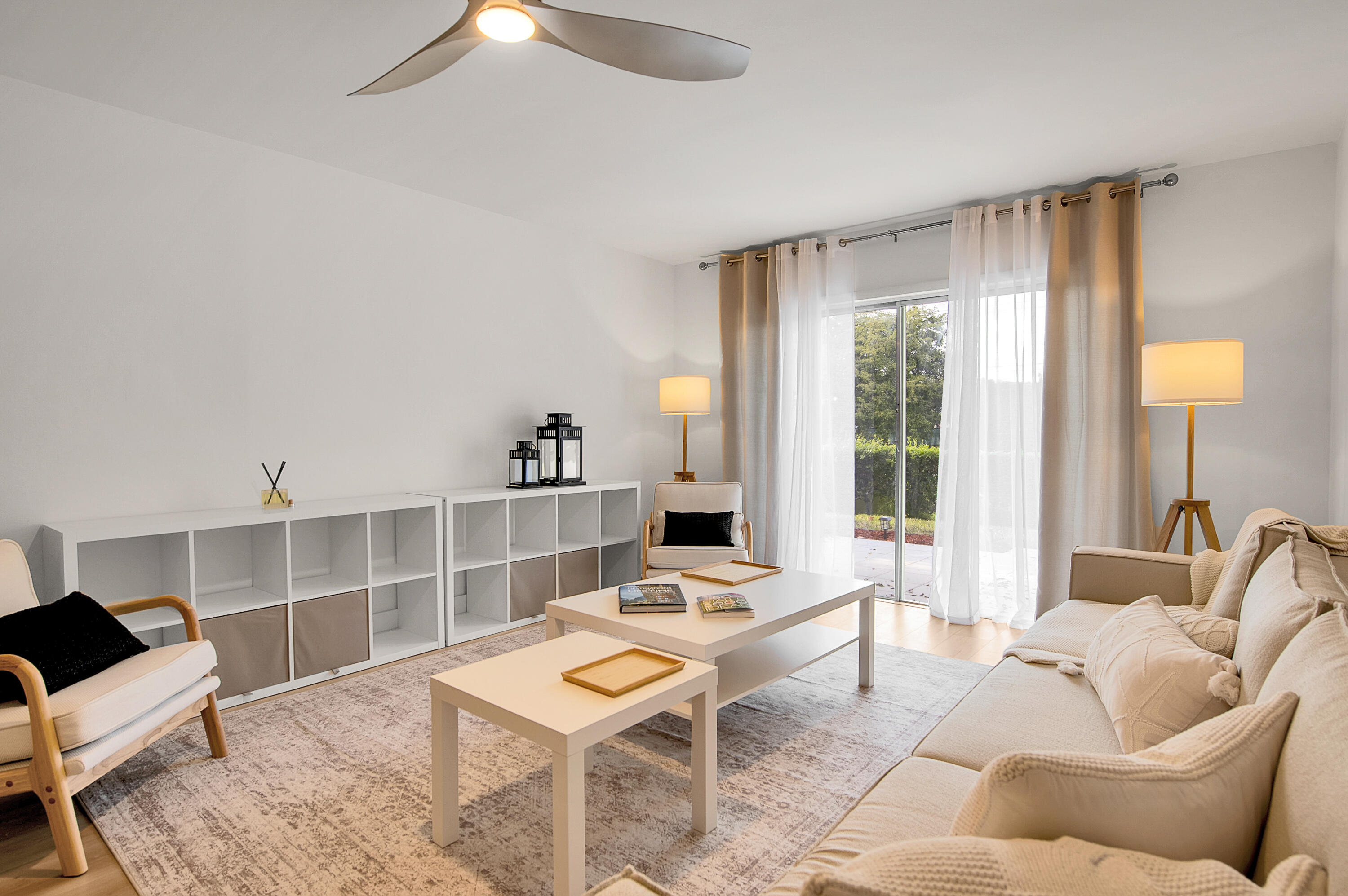 8799 Bella Vista Drive Boca Raton, FL 33433 - Photo 15 of 58 a living room with furniture a lamp and a large window
