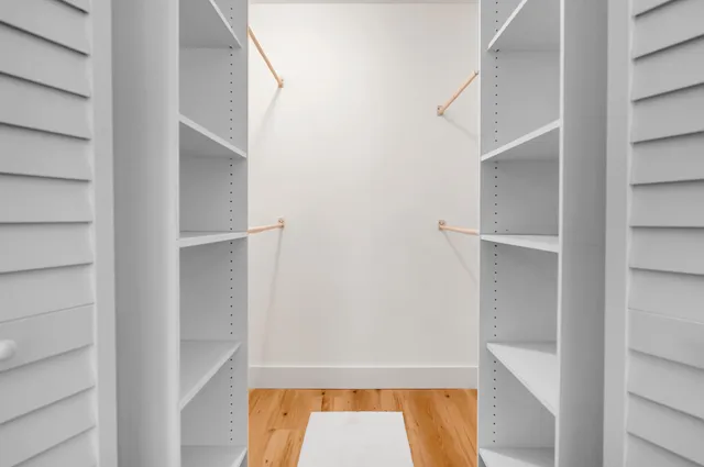 a living room with furniture a chandelier and a window
