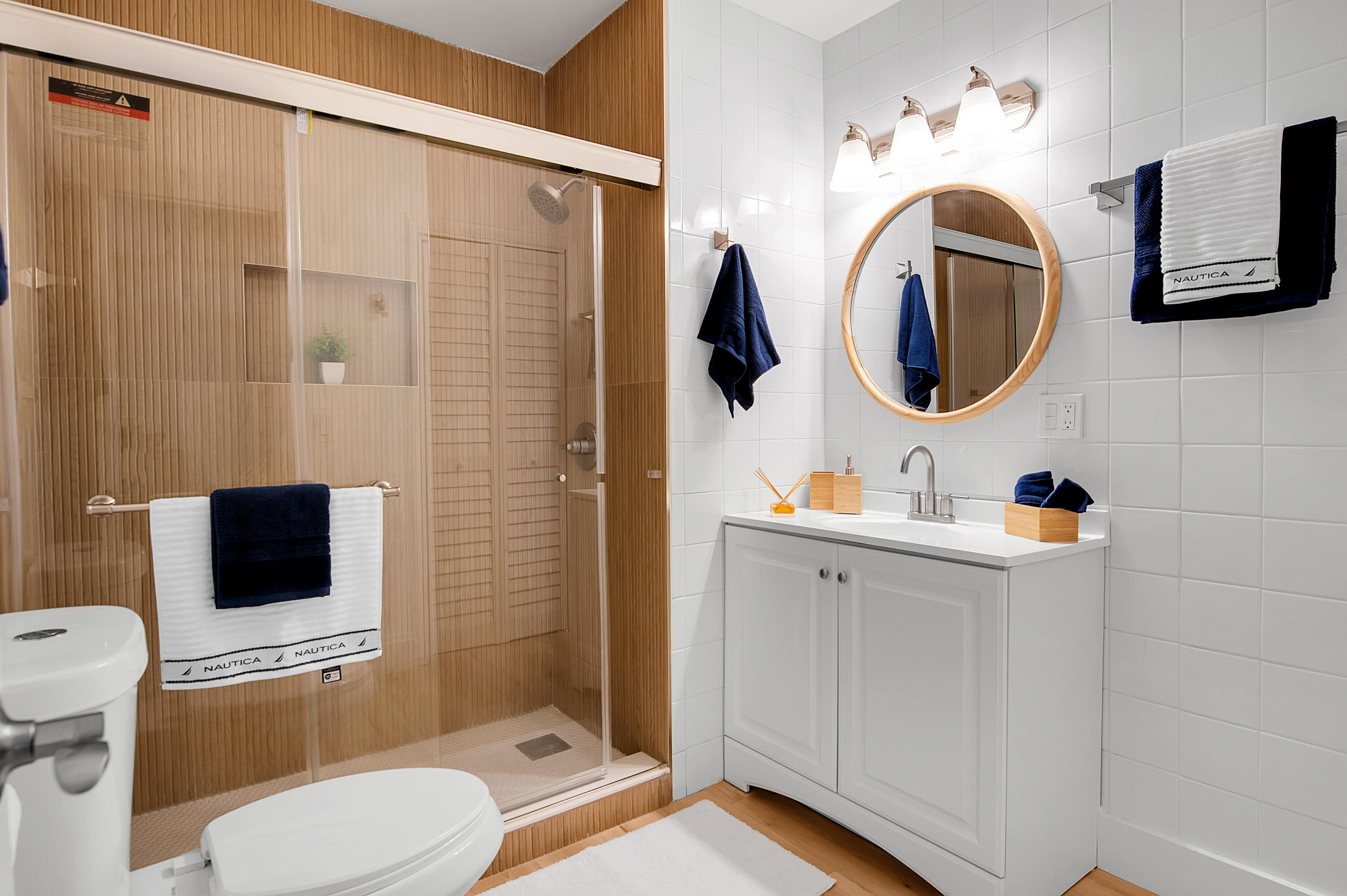 8799 Bella Vista Drive Boca Raton, FL 33433 - Photo 25 of 58 a bathroom with a toilet sink a mirror a vanity and shower