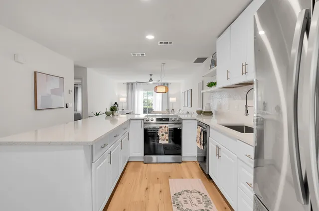 a kitchen with stainless steel appliances a refrigerator sink and cabinets