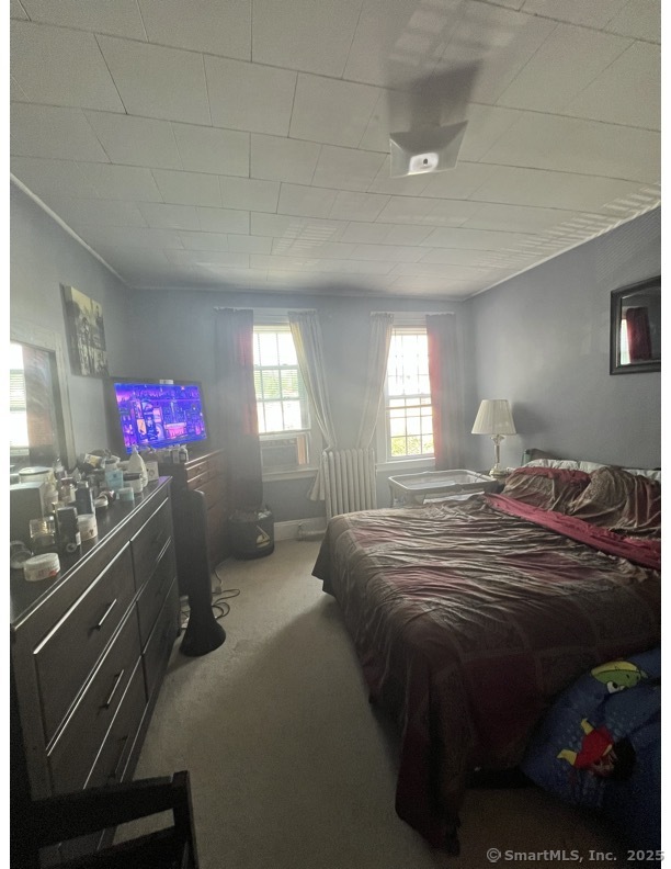 70 Burnham Street Hartford, CT 06112 - Photo 11 of 15 a bedroom with a bed and a chandelier