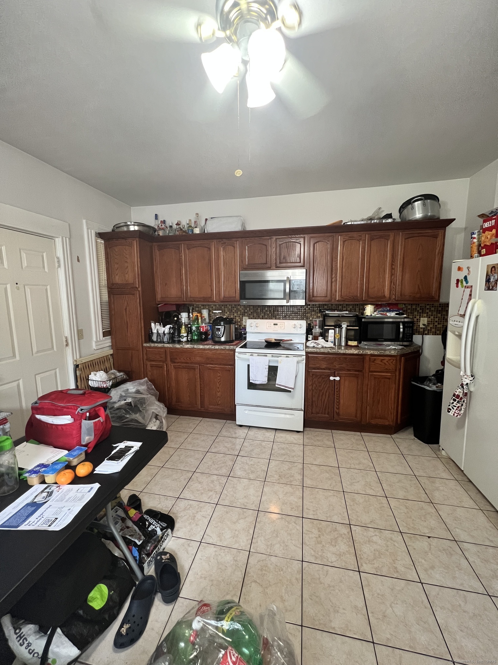 70 Burnham Street Hartford, CT 06112 - Photo 4 of 15 a kitchen with kitchen island granite countertop a stove sink and cabinets