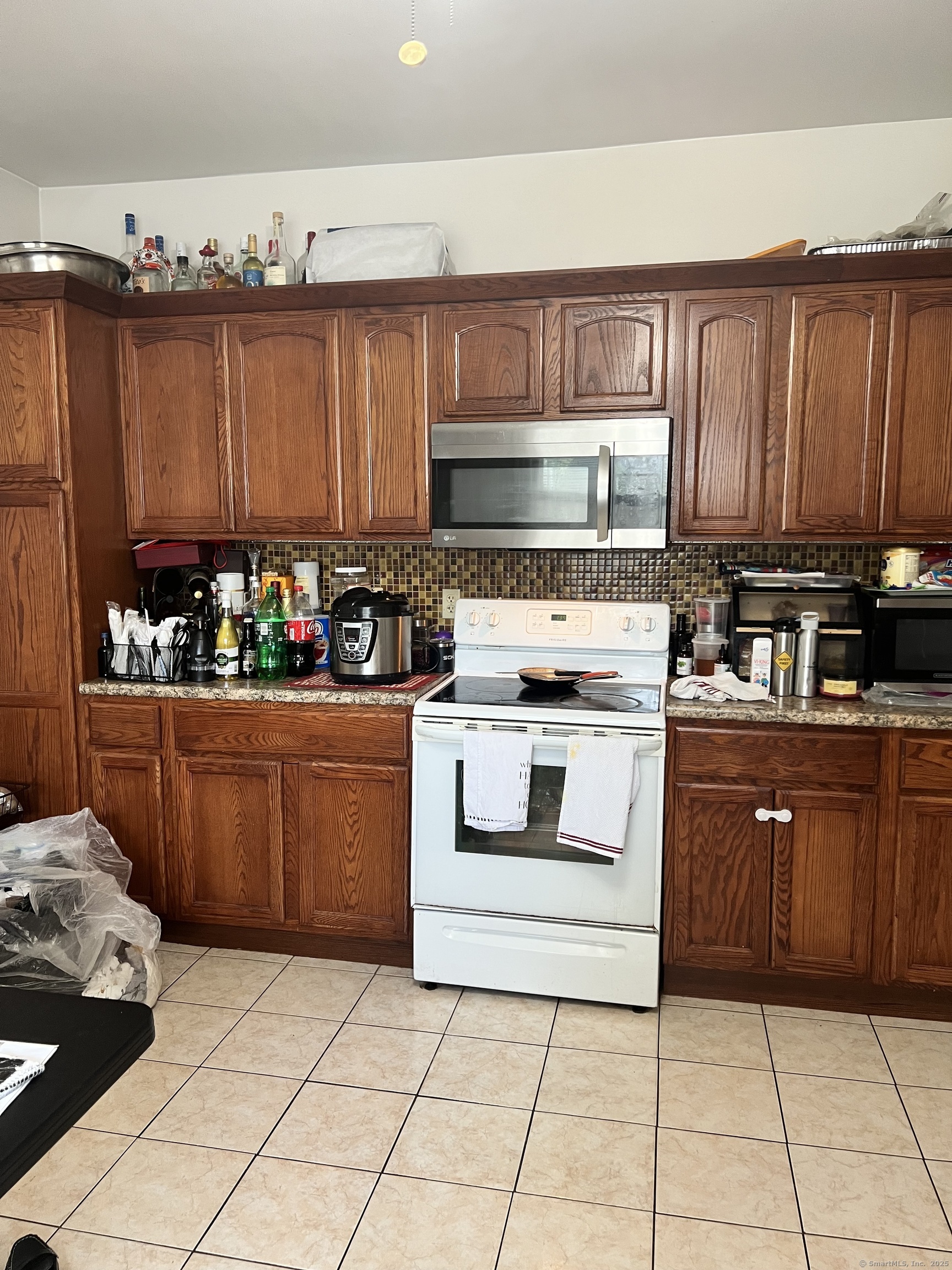 70 Burnham Street Hartford, CT 06112 - Photo 5 of 15 a kitchen with a stove a sink and a microwave