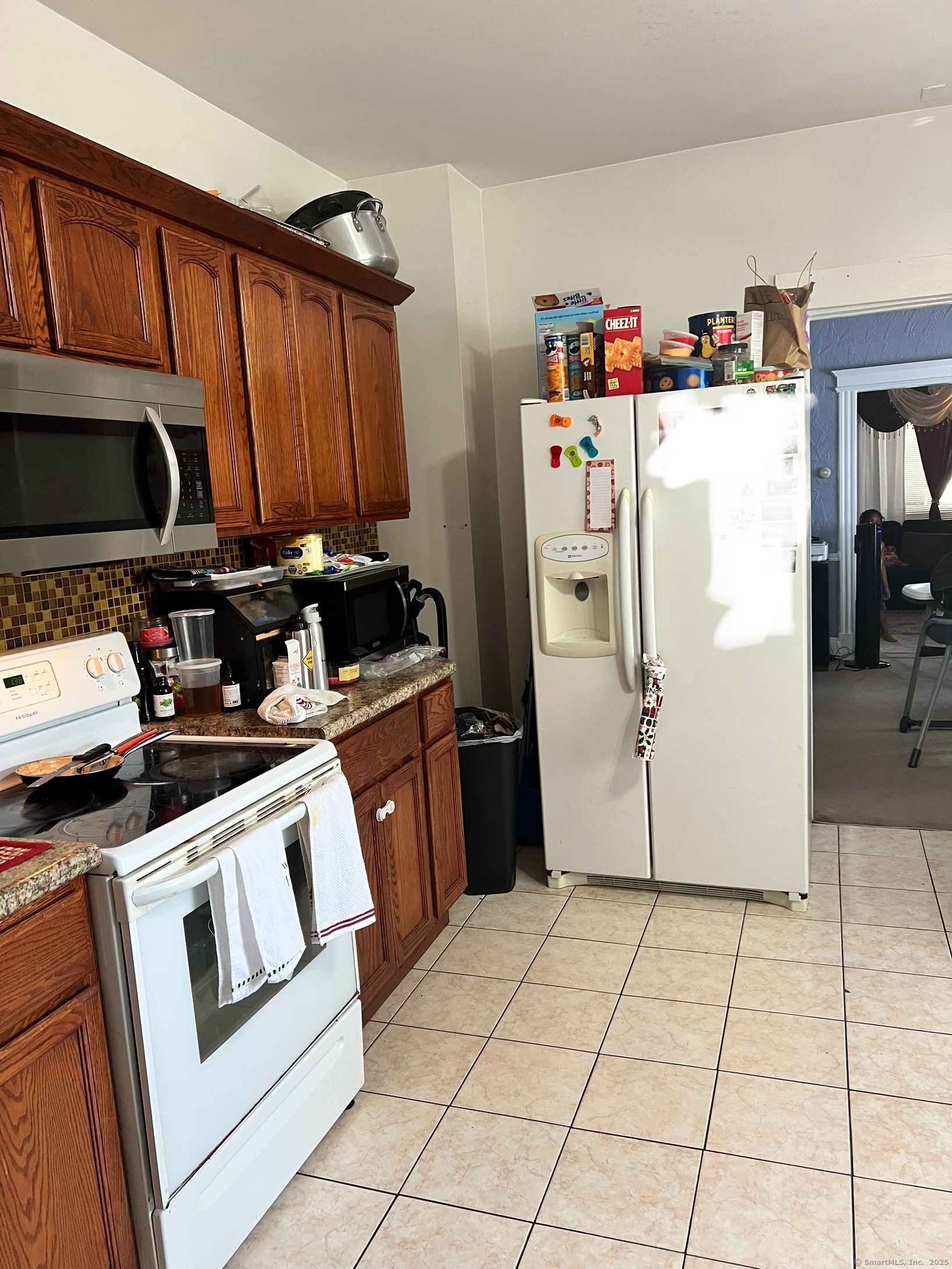 70 Burnham Street Hartford, CT 06112 - Photo 6 of 15 a kitchen with a refrigerator a stove a microwave and cabinets