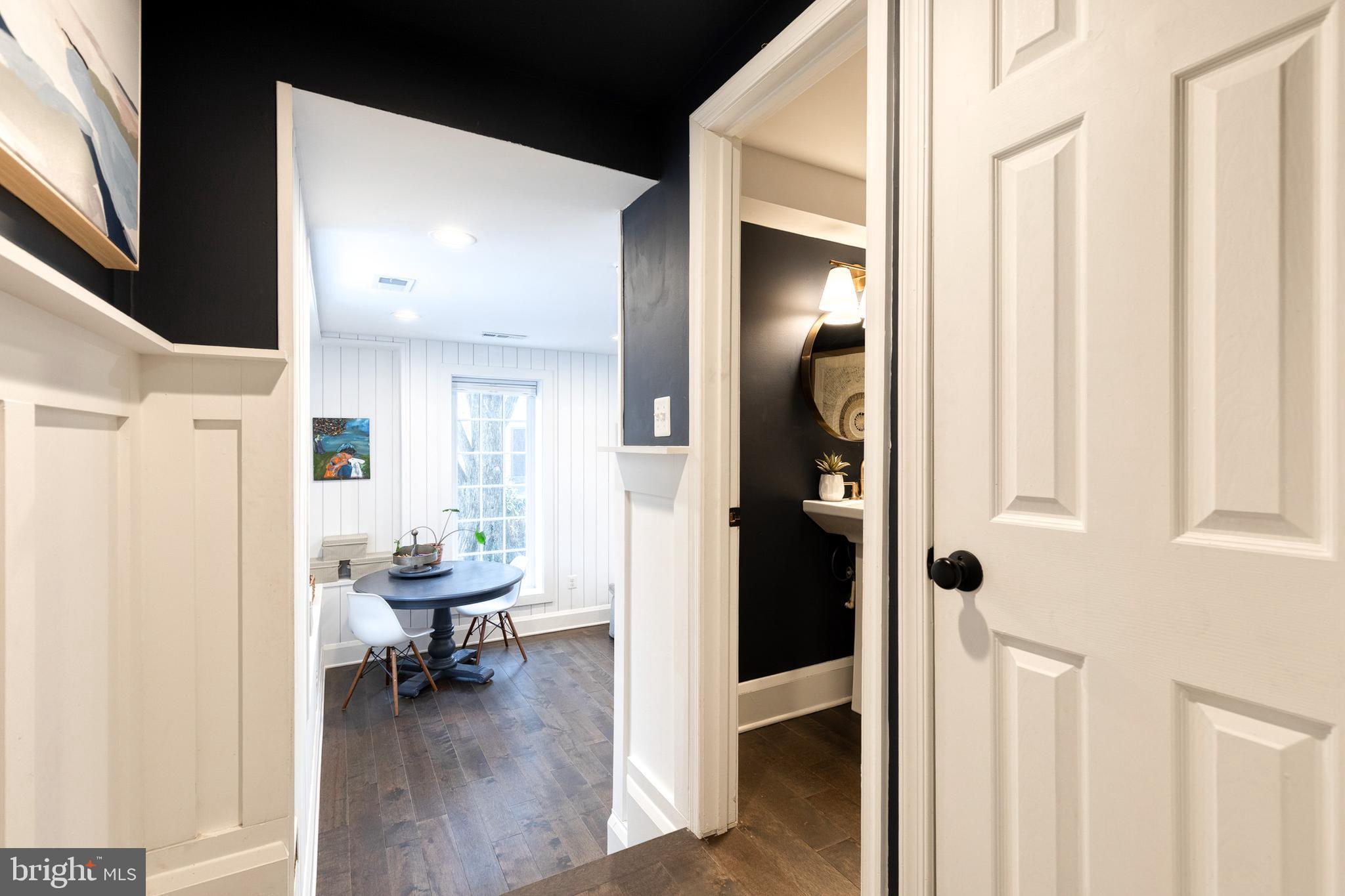 103 Witherspoon Road Baltimore, MD 21212 - Photo 31 of 62 a view of a hallway with wooden floor and a livingroom with furniture