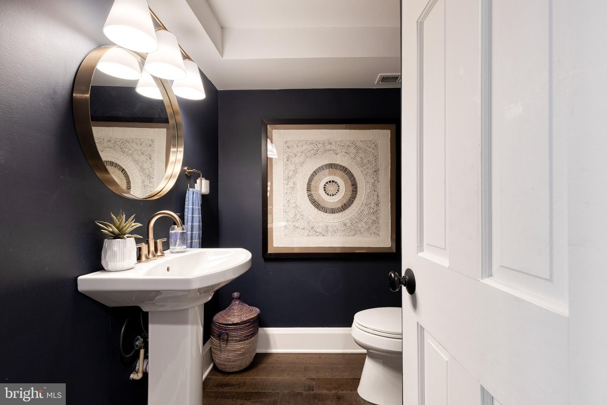 103 Witherspoon Road Baltimore, MD 21212 - Photo 33 of 62 a bathroom with a toilet sink and mirror