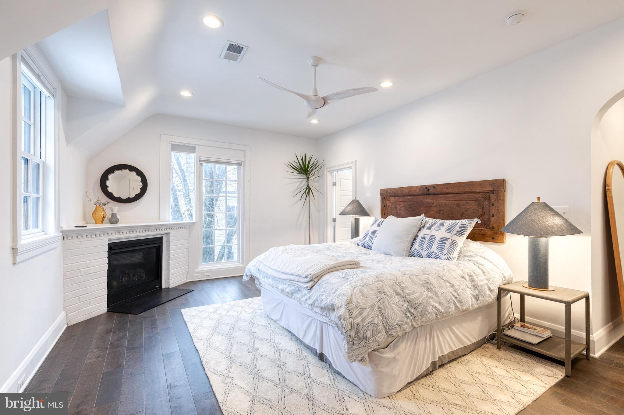 103 Witherspoon Road Baltimore, MD 21212 - Photo 35 of 62 a bedroom with a large bed and a fireplace