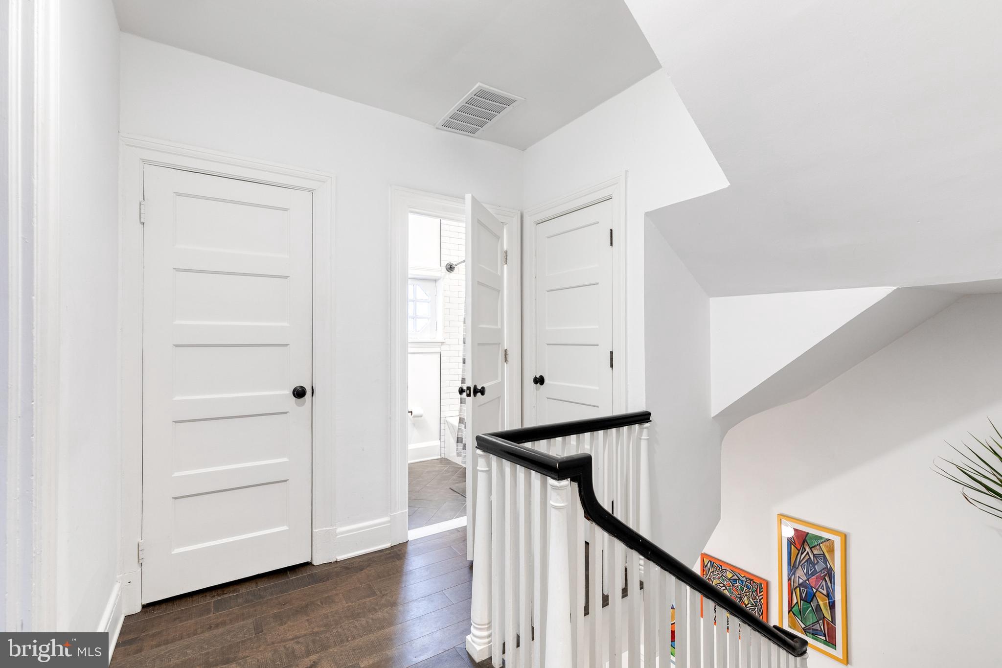 103 Witherspoon Road Baltimore, MD 21212 - Photo 46 of 62 a view of a hallway with wooden floor and staircase