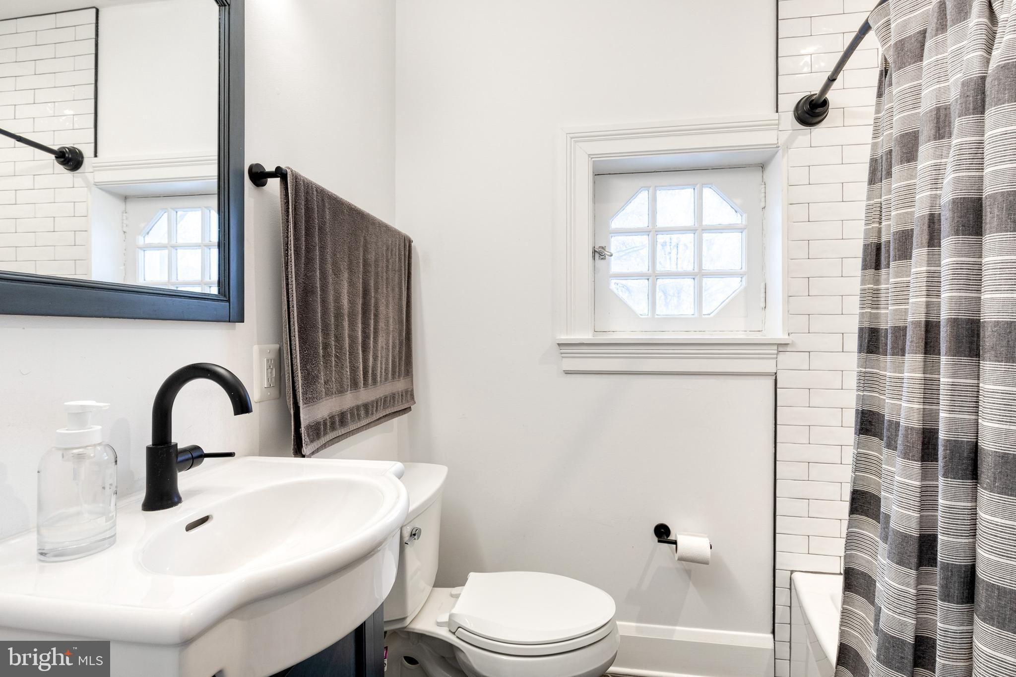 103 Witherspoon Road Baltimore, MD 21212 - Photo 49 of 62 a bathroom with a sink toilet and shower