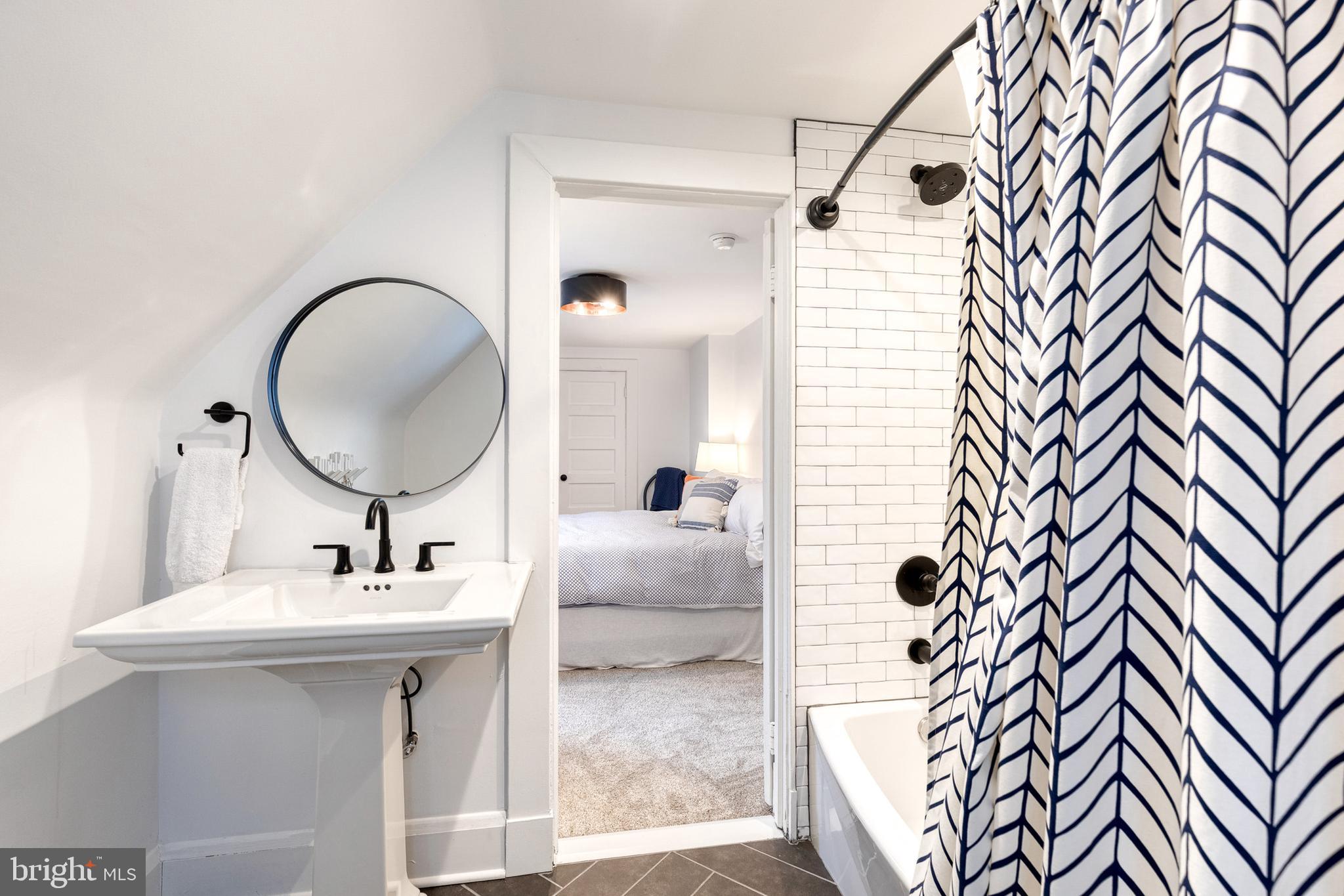 103 Witherspoon Road Baltimore, MD 21212 - Photo 56 of 62 a bathroom with a sink a mirror and a shower
