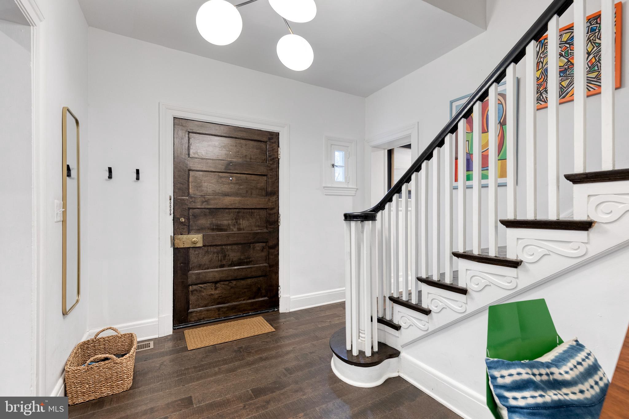 103 Witherspoon Road Baltimore, MD 21212 - Photo 6 of 62 a view of an entryway with wooden floor and stairs