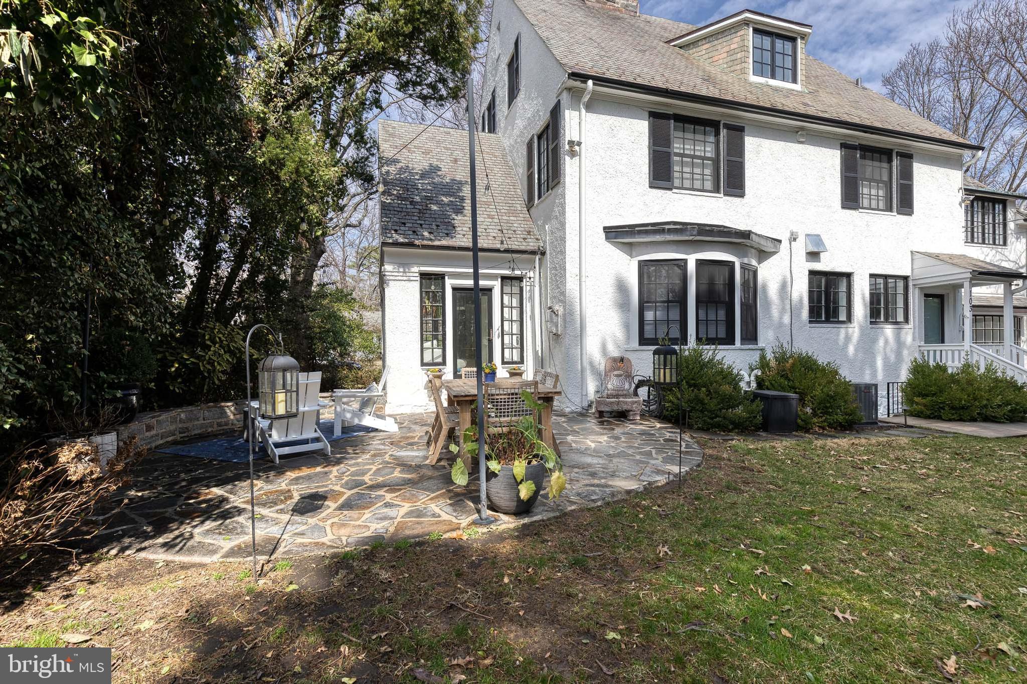 103 Witherspoon Road Baltimore, MD 21212 - Photo 61 of 62 a view of a white house next to a yard with potted plants and large trees