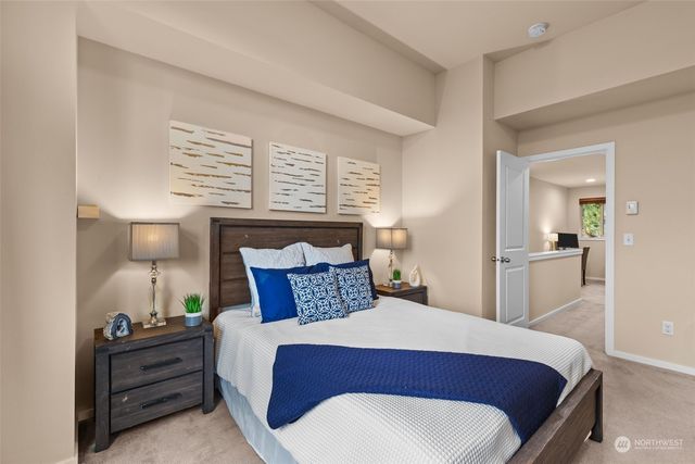 a bedroom with a bed and a potted plant