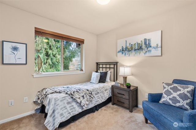 a bedroom with a bed and lamp