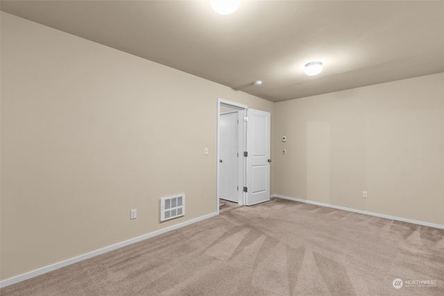 a view of backyard with potted plants and a table and chair