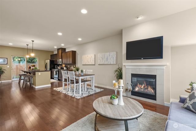 a view of a dining room with furniture and kitchen view