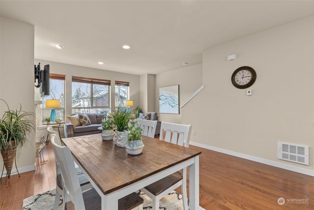 a kitchen with stainless steel appliances granite countertop counter space and chairs in it
