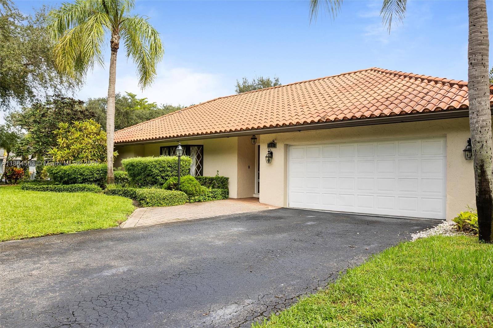 9031 North New River Canal Road Plantation, FL 33324 - Photo 26 of 32 a front view of a house with a yard and garage