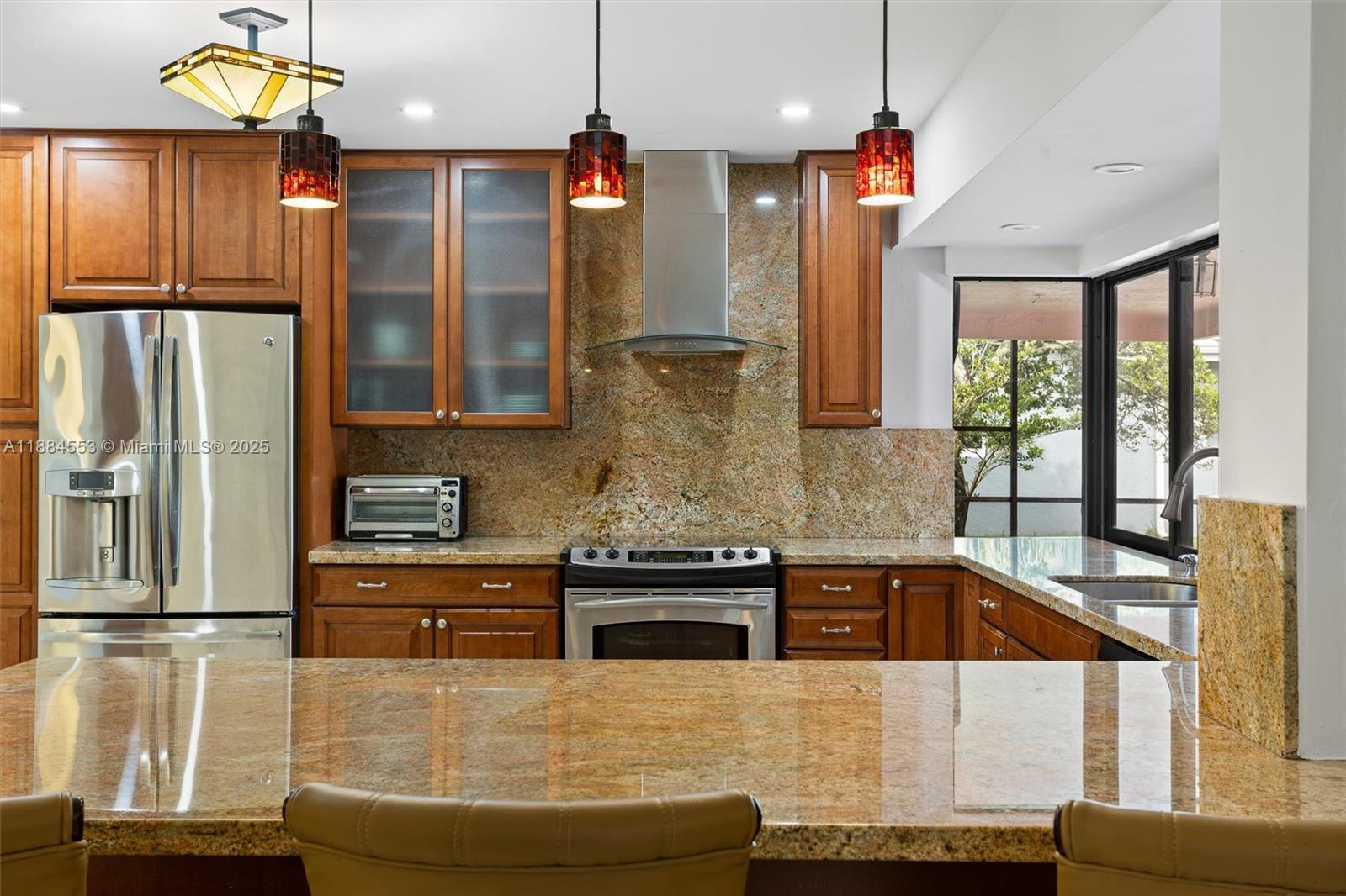9031 North New River Canal Road Plantation, FL 33324 - Photo 6 of 32 a kitchen with stainless steel appliances granite countertop a sink and a refrigerator