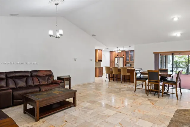 a living room with furniture a dining table and a piano