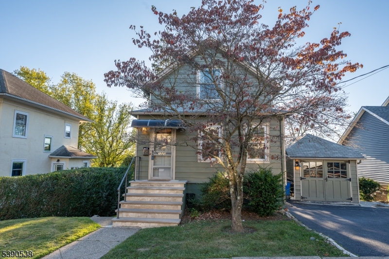 a front view of a house with a yard and a garden