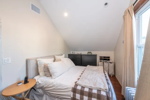 a bedroom with a bed and a chair