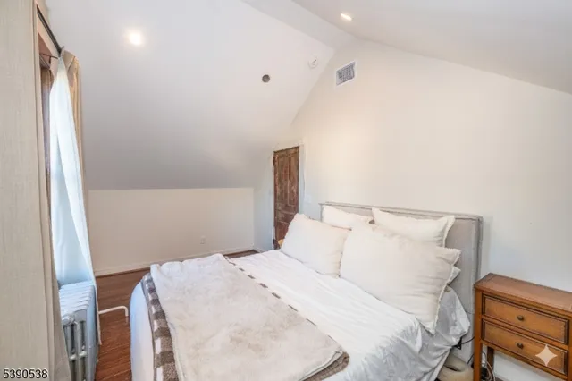 a bedroom with a bed and a mirror