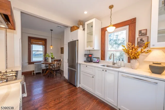 a kitchen with sink cabinets and wooden floor