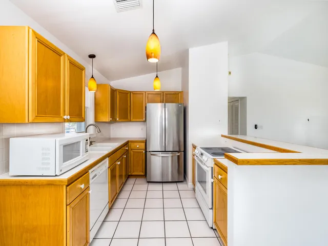 a view of a kitchen with stove and cabinets