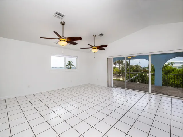 a view of a kitchen with a stove cabinets and chandelier fan