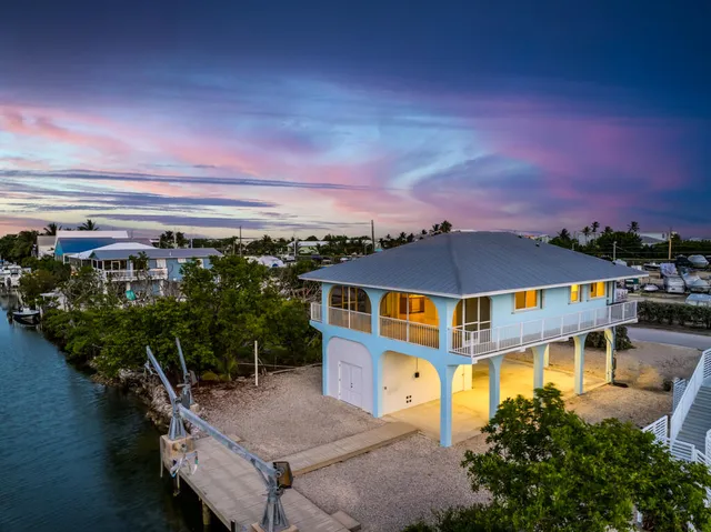 an aerial view of a house with a ocean view