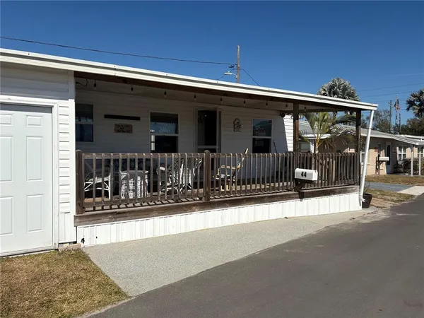 a view of a house with wooden fence