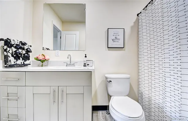 a bathroom with a toilet sink and mirror