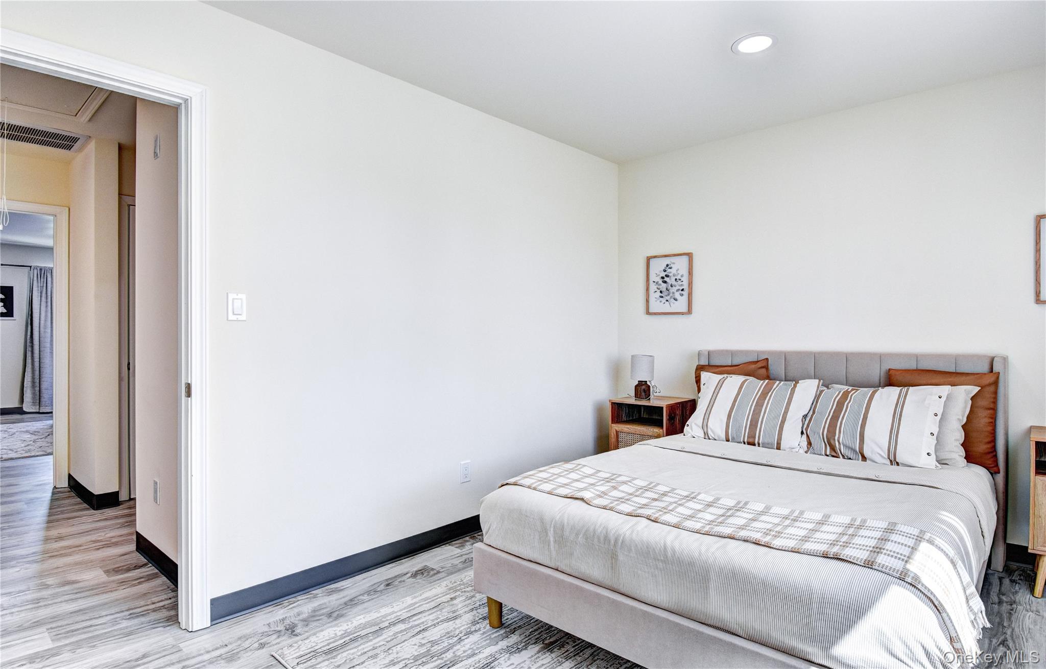 39 Levy Place Saugerties, NY 12477 - Photo 25 of 28 a bedroom with a bed and wooden floor