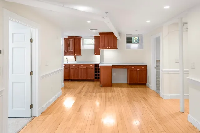a view of kitchen with stainless steel appliances cabinets and wooden floor