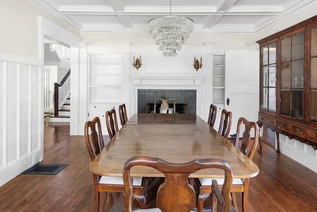 a view of a a dining room with furniture window and wooden floor