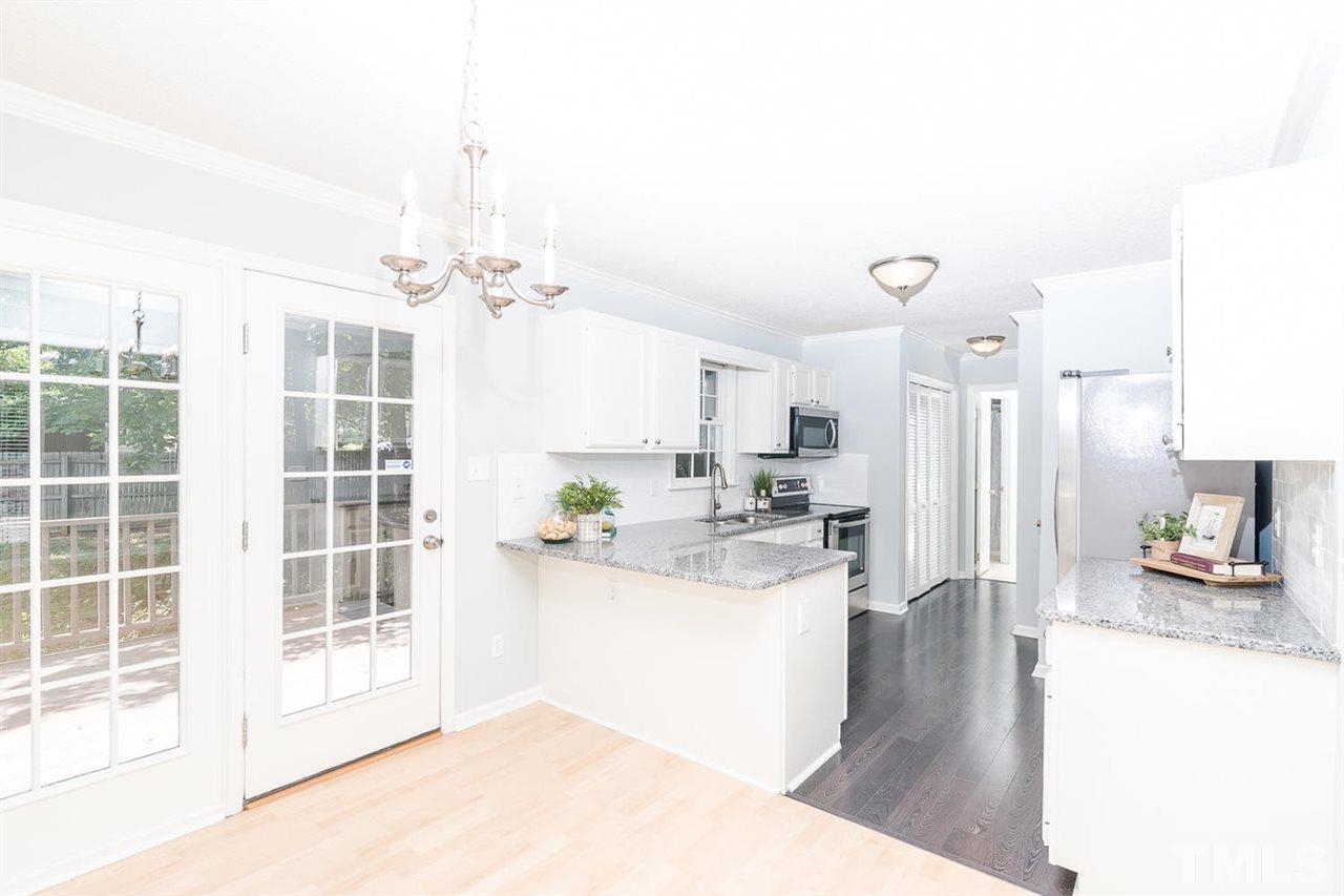 308 Crosspine Drive Raleigh, NC 27603 - Photo 4 of 11 Beautifully updated kitchen- new granite countertops, subway backsplash, and stainless steel appliances.