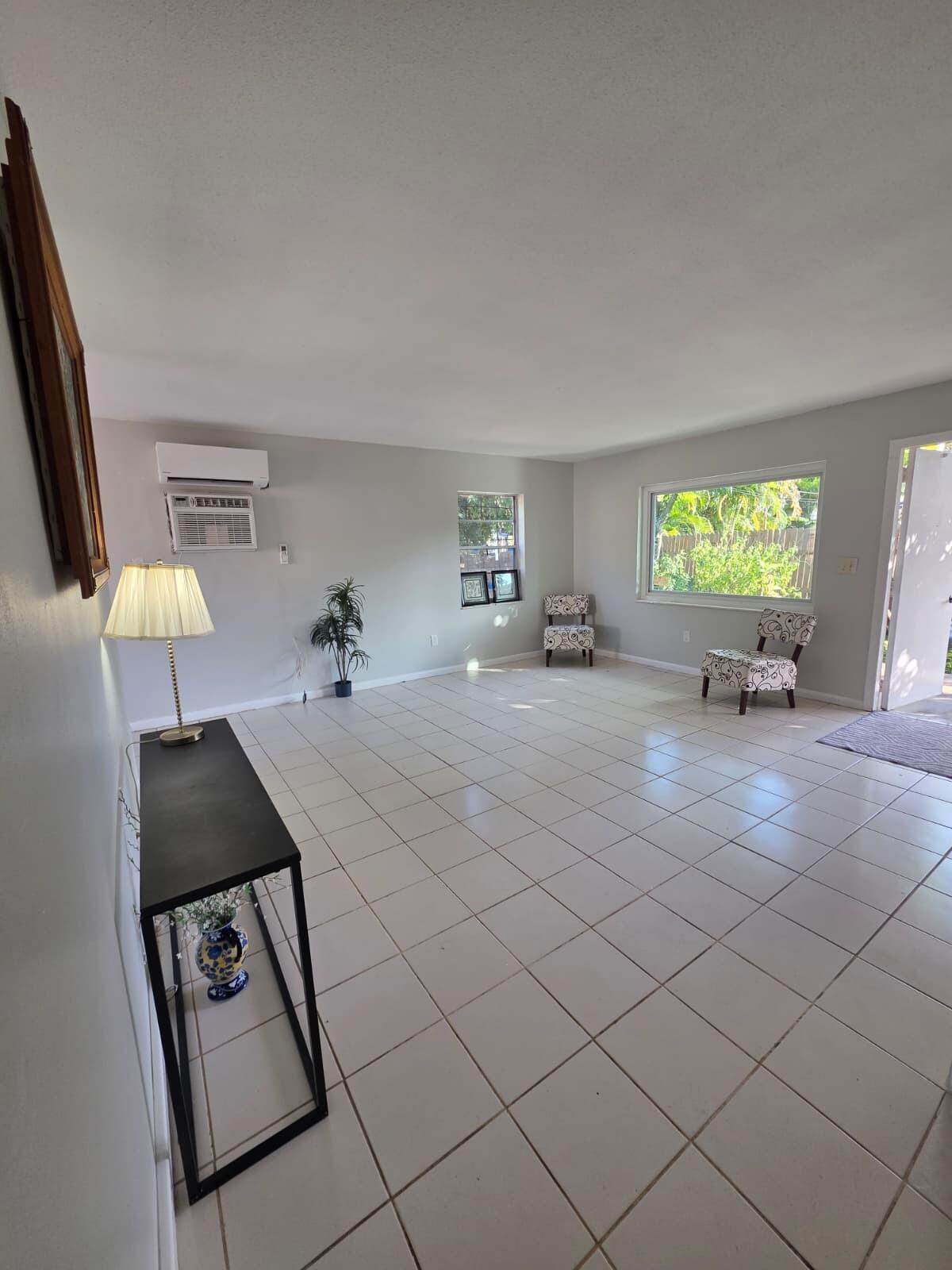 3386 Rudolph Road Lake Worth Beach, FL 33461 - Photo 11 of 25 a living room with furniture and a flat screen tv